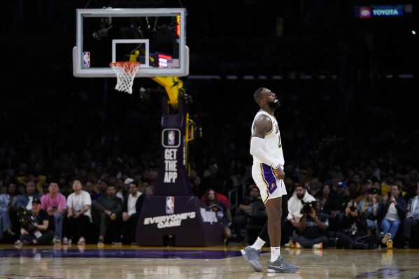 Los Angeles Lakers forward LeBron James (23) reacts after play was stopped due to a shot clock malfunction during the second half of an NBA basketball game against the Golden State Warriors in Los Angeles, Saturday, March 16, 2024. (AP Photo/Ashley Landis)