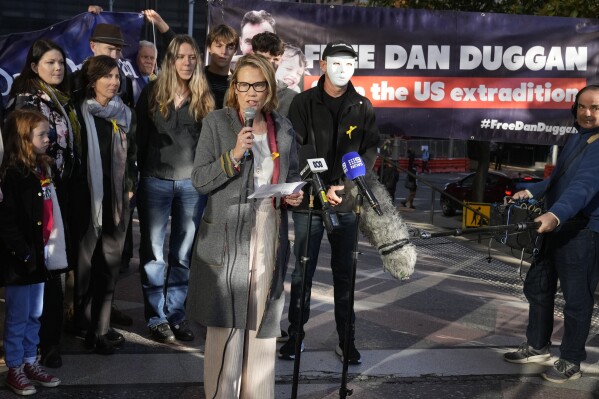 Saffrine Duggan speaks outside Downing Central Court in Sydney, Friday, May 24, 2024, where her husband Daniel will appear. A Sydney judge ruled that former U.S. Marine Corps pilot Daniel Duggan can be extradited to the United States on allegations he illegally trained Chinese aviators, leaving the Australian attorney-general Duggan's last hope of remaining in Australia. (AP Photo/Rick Rycroft)