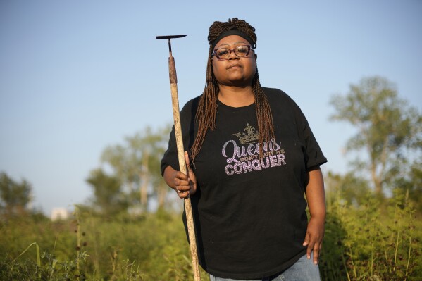 Faye Jacobs holds a hoe as she recalls her time working on an Arkansas prison farm, Monday, Sept. 18, 2023, in Kansas City, Mo. Jacobs worked on Arkansas prison farms that together total 21,000 acres before being released in 2018 after serving more than 26 years. (AP Photo/Charlie Riedel)