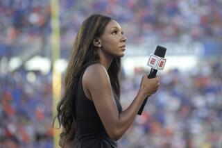 FILE - In this Aug. 24, 2019, file photo, ESPN's Maria Taylor works from the sideline during the first half of an NCAA college football game between Miami and Florida in Orlando, Fla. Taylor is leaving ESPN after the two sides were unable to reach an agreement on a contract extension. Taylor had been with ESPN since 2014 but her contract expired Tuesday, July 20, 2021. Her last assignment for the network was Tuesday night at the NBA Finals, where she was the pregame and postgame host for the network's “NBA Countdown” show.  (AP Photo/Phelan M. Ebenhack, File)