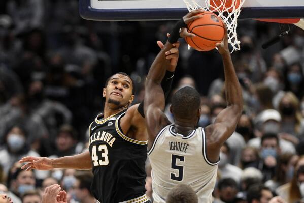Villanova forward Eric Dixon (43) defends against Georgetown center Timothy Ighoefe (5) during the first half of an NCAA college basketball game, Saturday, Jan. 22, 2022, in Washington. (AP Photo/Nick Wass)
