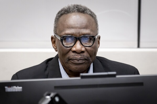 Ali Muhammad Ali Abd al-Rahman, a Sudanese national, during a hearing at the International Criminal Court in The Hague, The Netherlands, Thursday, Oct. 19, 2023. The alleged former militia chief is on trial for 31 war crimes and crimes against humanity, including murder, rape and torture in 2003 to 2004. (Koen van Weel/Pool Photo via AP)