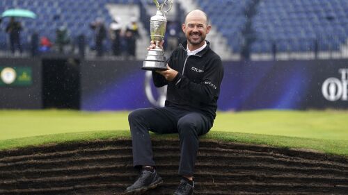 United States' Brian Harman poses for the media as he holds the Claret Jug trophy for winning the British Open Golf Championships at the Royal Liverpool Golf Club in Hoylake, England, Sunday, July 23, 2023. (David Davies/PA via AP)