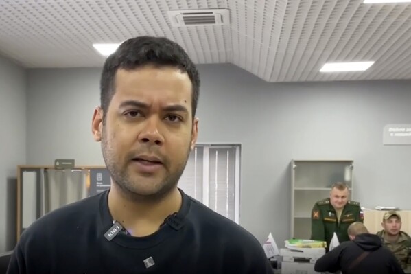 This undated still image taken from video posted on pro-Kremlin media sites appears to show Wilmer Puello-Mota in a military enlistment office in Siberia. Puello-Mota, a U.S. Air Force veteran and former elected official in Massachusetts who fled the U.S. after being charged with possessing sexually explicit images of a child, told his lawyer he joined Russia’s army. (AP Photo)