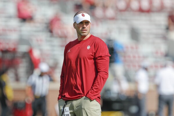 FILE - Oklahoma defensive coordinator Alex Grinch watches before the start of a NCAA college football game against Tulane on Saturday, Sept. 4, 2021, in Norman, Okla. Wisconsin coach Luke Fickell announced Thursday, Feb. 1, 2024, that he has hired Grinch as the school's new defensive coordinator. Grinch replaces Colin Hitschler, who left to join new Alabama coach Kalen DeBoer’s staff. (AP Photo/Alonzo Adams, File)