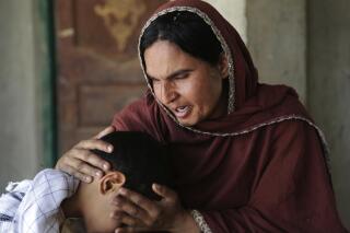 FILE In this picture taken on May 4, 2017, Kausar Parveen comforts her child who was allegedly raped by a mullah or religious cleric, in Kehror Pakka, Pakistan. A Pakistani aid group dedicated to child protection said Friday, April 29, 2022, its data shows assaults and sexual abuse of children have surged by nearly a third in the country last year.  The organization’s director said she fears an increase in “dark web” gangs trading in child pornography and buying and selling children are to blame for the increase, along with lockdowns imposed during the coronavirus pandemic. (AP Photo/K.M. Chaudary, File)