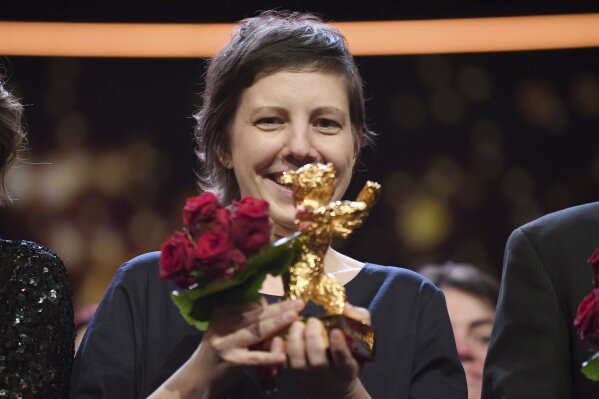 
              Director Adina Pintilie holds the golden bear for 'Touch me not' during the awarding ceremony of the 68th edition of the International Film Festival Berlin, Berlinale, in Berlin, Germany, Saturday, Feb. 24, 2018. (Ralf Hirschberger/dpa via AP)
            