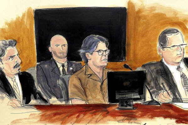 
              FILE - In this April 13, 2018 courtroom sketch, Keith Raniere, center, leader of the secretive group NXIVM, attends a hearing at court in the Brooklyn borough of New York. A New York City jury is set to hear opening statements and testimony at the sex-trafficking case against a self-help guru. The trial beginning Tuesday, May 7, 2019, is expected to feature testimony from women who claim that they were forced to have sex with Raniere. (Elizabeth Williams via AP, File)
            