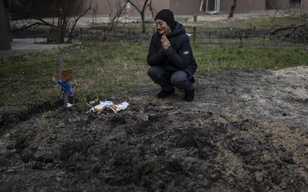 FILE - Tanya Nedashkivs'ka, 57, mourns the death of her husband on the site where he was buried, in Bucha, on the outskirts of Kyiv, Ukraine, Monday, April 4, 2022. (AP Photo/Rodrigo Abd)