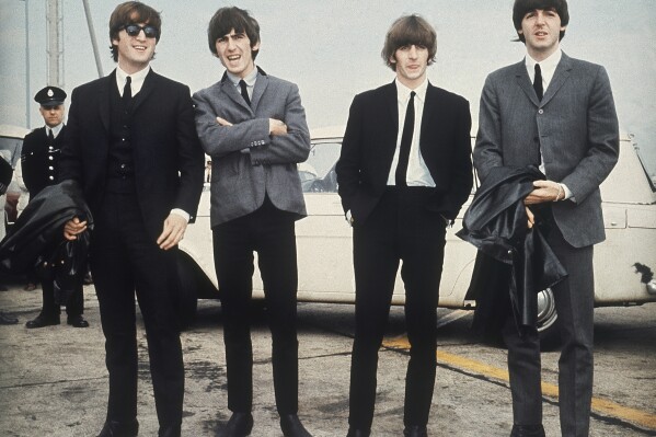 FILE - The Beatles, from left, John Lennon, George Harrison, Ringo Starr and Paul McCartney arrive in Liverpool, England on July 10, 1964, for the premiere of their movie "A Hard Day's Night." The final Beatles recording featuring John, Paul, George and Ringo is here. Released Thursday and titled “Now and Then,” the song comes from a batch of unreleased demos written by the late John Lennon in the ’70s. (AP Photo, File)