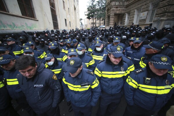 Police block a street during a rally to demand new parliamentary elections in the country, near the Parliament's building in Tbilisi, Georgia, Monday, Nov. 25, 2024. (AP Photo/Zurab Tsertsvadze)