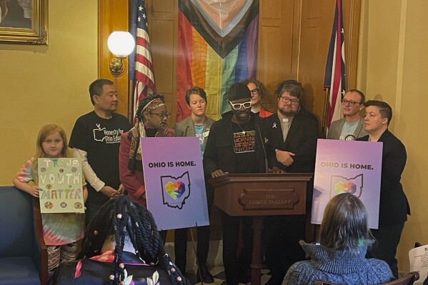 Organizers including clergy, business owners, social workers and transgender individuals gather in the Ohio Statehouse for a press conference on Wednesday, Dec. 13, 2023 in Columbus, Ohio in opposition to a bill that would ban gender affirming care for minors and ban transgender athletes from participating in girls' and women's sports. The Ohio Republican-led state Senate cleared the measure along party lines Wednesday. (AP Photo/Samantha Hendrickson)