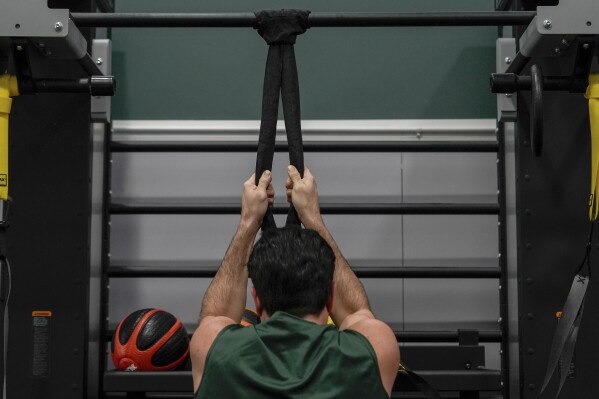 Damon LaSalle engages in rehab exercises before returning to playing volleyball following an ankle injury, Friday, Feb. 21, 2025, at New Jersey City University in Jersey City, N.J. (AP Photo/Julia Demaree Nikhinson)