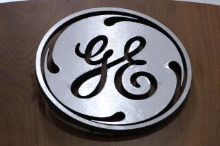 FILE - This Jan. 16, 2014 file photo shows the General Electric logo at a store in Cranberry Township, Pa. As the coronavirus pandemic threatened to overwhelm Chinese hospitals in 2020, Chinese resellers appear to have colluded to inflate the prices of ventilators and other essential medical equipment from multinational companies including Siemens, GE, and Philips, according to a review of recent public records on the sale of medical equipment in China. (AP Photo/Gene J. Puskar, File)