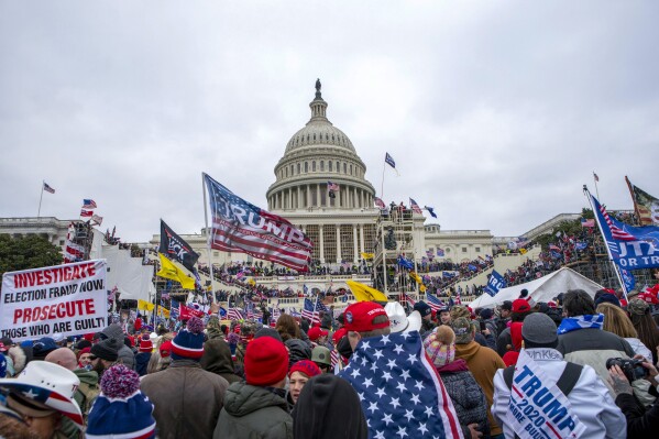 FILE - Rioters loyal to President Donald Trump at the U.S. Capitol in Washington, Jan. 6, 2021. A former leader of the far-right Proud Boys extremist group has been sentenced to more than three years behind bars for joining a plot to attack the U.S. Capitol nearly three years ago. Charles Donohoe was the second Proud Boy to plead guilty to conspiring with other group members to obstruct the Jan. 6, 2021, joint session of Congress for certifying President Joe Biden’s electoral victory. (AP Photo/Jose Luis Magana, File)