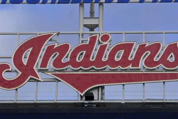 The Indians sign hangs at Progressive Field before the first baseball game of a doubleheader against the Chicago White Sox, Thursday, Sept. 23, 2021, in Cleveland. On Sunday, one of the American League's charter members will play its final home game of 2021, and also its last at Progressive Field as the Indians, the team's name since 1915, when "Shoeless" Joe Jackson was the starting right fielder on opening day. Much more than a late-season matchup against the Chicago White Sox, the home finale will signify the end of one era and beginning of a new chapter for the team, which will be called the Cleveland Guardians next season. (AP Photo/Tony Dejak)