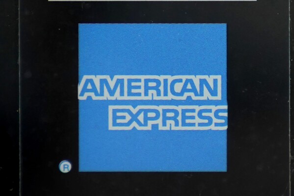 FILE - An American Express logo is attached to a door in Boston's Seaport District, Wednesday, July 21, 2021. American Express earnings are reported on Friday. (AP Photo/Steven Senne, File)