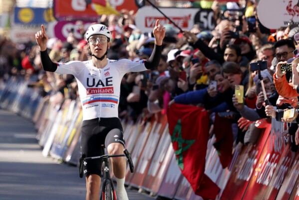 Slovenia's Tadej Pogacar of the UAE Emirates team crosses the finish line to win the Belgian cycling classic and UCI World Tour race Liege Bastogne Liege, in Liege, Belgium, Sunday, April 21, 2024. (AP Photo/Geert Vanden Wijngaert)
