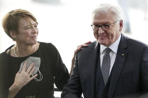 Reelected German President Frank-Walter Steinmeier is congratulated by his wife Elke Buedenbender , left, during the German Federal Assembly which came together to elect the country's president in Berlin, Germany, Sunday, Feb. 13, 2022 (AP Photo/Michael Sohn, Pool)