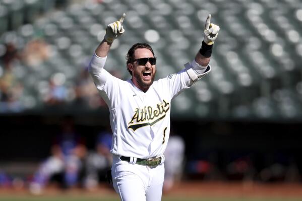 Oakland Athletics' Jed Lowrie celebrates after his winning RBI-single against the Texas Rangers during the ninth inning of a baseball game in Oakland, Calif., Sunday, May 29, 2022. (AP Photo/Jed Jacobsohn)