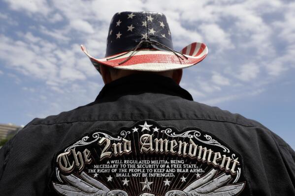 FILE - A man wears a patriotic-themed cowboy hat during a pro gun-rights rally at the Texas Capitol, April 14, 2018, in Austin, Texas. Guns have long been a part of Texas culture — both in the state’s mythology and in reality. But to equate the number of guns with the number of people killed by guns strikes some as a false equivalence. (AP Photo/Eric Gay, File)
