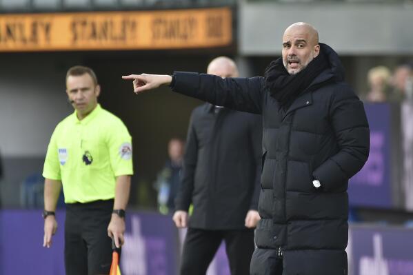 Manchester City's head coach Pep Guardiola instructs his players during the Premier League soccer match between Burnley and Manchester City at Turf Moor, in Burnley, England, Saturday, April 2, 2022. (AP Photo/Rui Vieira)