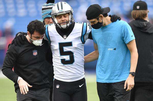 Carolina Panthers kicker Zane Gonzalez (5) is helped off the field after an apparent injury during practice before an NFL football game against the Buffalo Bills, Sunday, Dec. 19, 2021, in Orchard Park, N.Y. (AP Photo/Adrian Kraus)