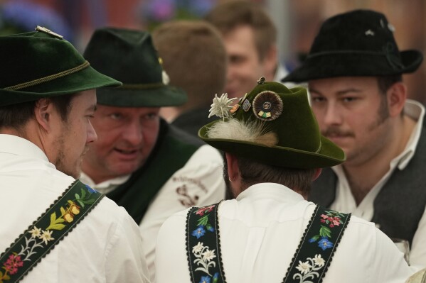 Men dressed in traditional clothes attend the German Championships in Fingerhakeln or finger wrestling, in Pang, near Rosenheim, Germany, Sunday, April 27, 2025. (AP Photo/Matthias Schrader)