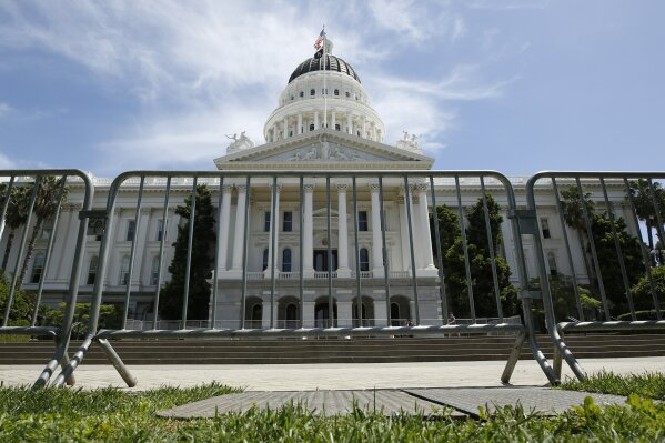A line of barriers stand near the west steps of the state Capitol in Sacramento, Calif., Wednesday, April 22, 2020. The barricades were placed after the California Highway Patrol announced Wednesday, that it is temporarily banning rallies at the state Capitol and other state facilities due to the pandemic. The change came after hundreds of protestors gathered on the Capitol grounds Monday, many without masks or following recommendations to remain six feet apart to slow the spread of the coronavirus. (AP Photo/Rich Pedroncelli)