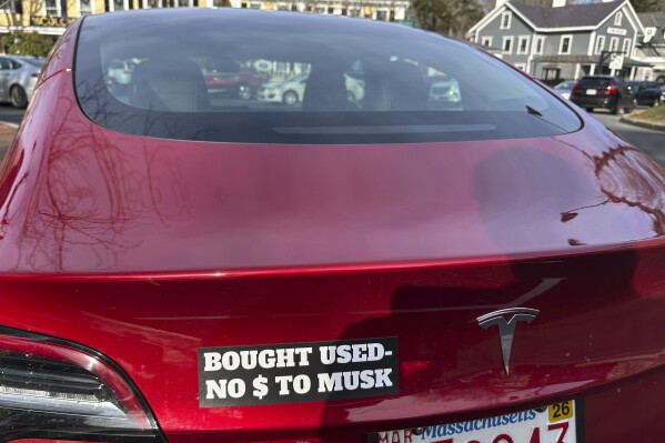 A Tesla with a sticker referring to the car's purchase is shown on Sunday, Dec. 15, 2024, in Concord, Mass. (AP Photo/Peter Morgan, File)