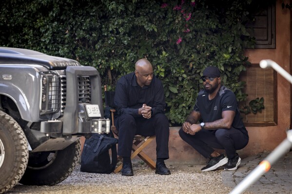 This image released by Sony Pictures Entertainment shows Denzel Washington, left, and director Antoine Fuqua on the set of "The Equalizer 3." (Stefano Montesi/Sony Pictures Entertainment via AP)