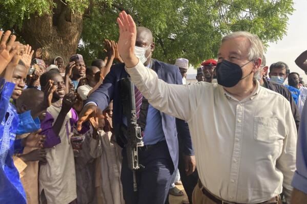 United Nations Secretary-General Antonio Guterres, waves to the crowds upon arrival in Maiduguri, Nigeria, Tuesday, May 3, 2022. Guterres on Tuesday said the reintegration of extremist rebels who have defected from the jihadi Boko Haram group that has waged a decade-long insurgency against the West African nation is "the best thing we can do for peace." (AP Photo/Chinedu Asadu)