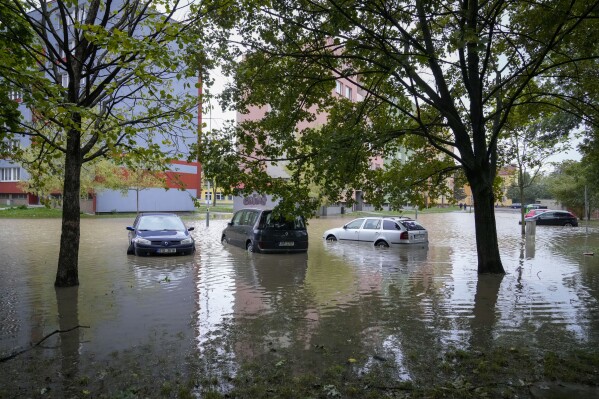Vehicles are partially covered by water during floods in Ostrava, Czech Republic, Monday, Sept. 16, 2024. (AP Photo/Darko Bandic)