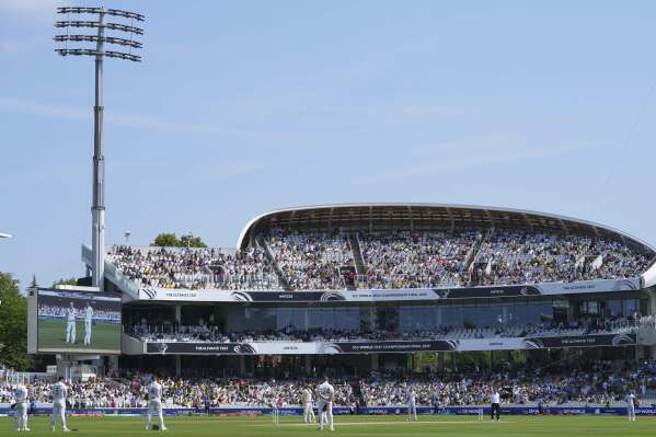 Players observe a minute of silence before the start of play to honor the victims of Thursday's plane crash in India, on day three of the World Test Championship final between South Africa and Australia at Lord's cricket ground in London, Friday, June 13, 2025. (AP Photo/Kirsty Wigglesworth)