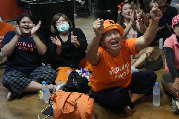 Supporters of Move Forward party cheer as they watch the counting of votes on television at Move Forward Party headquarters in Bangkok, Thailand, Sunday, May 14, 2023. Vote counting was underway Sunday in Thailand's general election, touted as a pivotal chance for change nine years after incumbent Prime Minister Prayuth Chan-ocha first came to power in a 2014 coup. (AP Photo/Sakchai Lalit)
