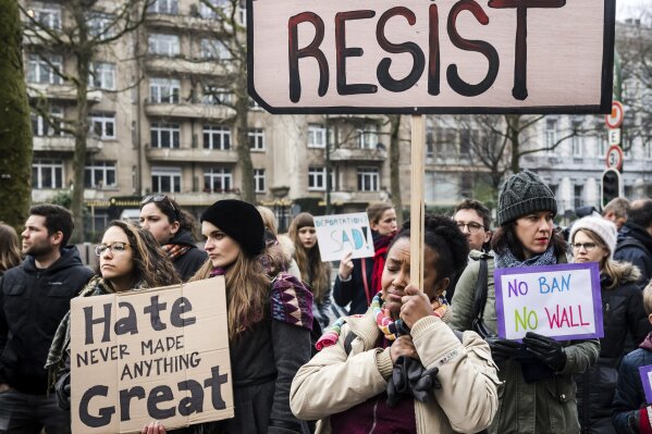 FILE - In this  Sunday, Feb. 12, 2017 file photo, demonstrators protest against U.S. President Donald Trump's executive order banning travelers from several predominantly Muslim countries from entering the United States, in front of the U.S. embassy in Brussels. (AP Photo/Geert Vanden Wijngaert)