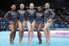 Team USA from left to right, Jordan Chiles, Hezly Rivera, Jade Carey, Simone Biles and Sunisa Lee pose for photos after competing in the women's artistic gymnastics qualification round at Bercy Arena at the 2024 Summer Olympics, Sunday, July 28, 2024, in Paris, France. (AP Photo/Charlie Riedel)