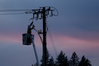 
              FILE - In this Nov. 26, 2018, file photo, a Pacific Gas & Electric lineman works to repair a power line in fire-ravaged Paradise, Calif. A U.S. judge who has berated Pacific Gas & Electric Co. for its role in wildfires in California is demanding more answers from the utility. In a court filing on Thursday, Feb. 14, 2019, Judge William Alsup asked PG&E whether it was in compliance with a state law that requires it to clear vegetation around electric lines. The judge also questioned a part of the utility's recently submitted wildfire mitigation plan. (AP Photo/Rich Pedroncelli, File)
            