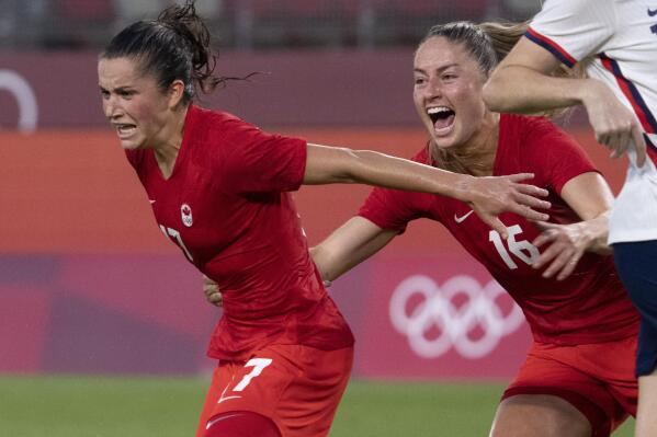 Canada midfielder Jessie Fleming (17) celebrates her game winning penalty kick goal with teammate Janine Beckie (16)  during a women's semifinal soccer match against United States at the 2020 Summer Olympics, Monday, Aug. 2, 2021, in Kashima, Japan. (Frank Gunn/The Canadian Press via AP)