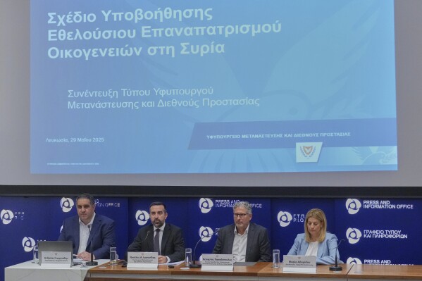 Cyprus' deputy minister for migration Nicholas Ioannides, second left, explains how a new voluntary repatriation program for Syrian families living in Cyprus will work during a press conference, at the Press and Informations office in the capital Nicosia, Cyprus, Thursday, May 29, 2025. (AP Photo/Petros Karadjias)