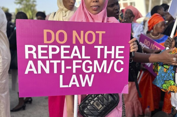 Jaha Dukureh, the founder of Safe Hands for Girls, pickets outside parliament in Serrekunda, Gambia, Monday, March 18, 2024. The West African nation of Gambia could become the first country in the world to reverse a ban on female genital cutting, a practice that experts say is dangerous and has no benefits. Lawmakers are voting Monday on legislation that seeks to repeal the 2015 ban. (Hadim Thomas-Safe Hands for Girls via AP)