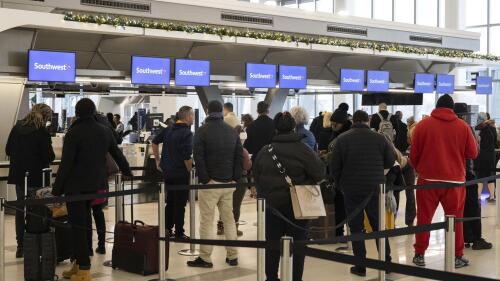 FILE - Passengers wait in line to check in for their flights at Southwest Airlines service desk at LaGuardia Airport, on Dec. 27, 2022, in New York. The Biden administration is working on new regulations that would require airlines to compensate passengers and cover their meals and hotel rooms if they are stranded for reasons within the airline's control. The White House said President Joe Biden and Transportation Secretary Pete Buttigieg would announce the start of the rulemaking process Monday May 8, 2023. (AP Photo/Yuki Iwamura, File)