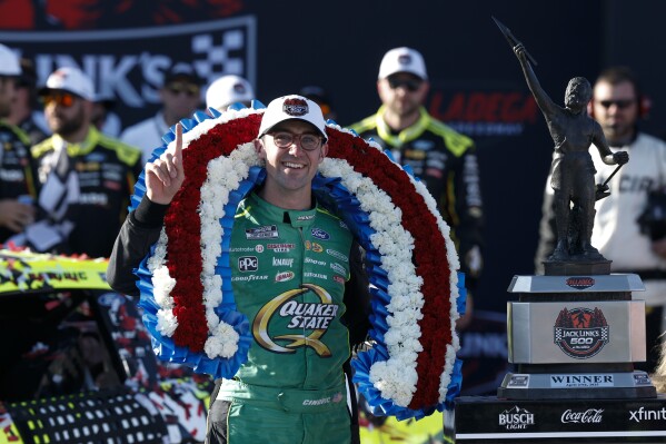 NASCAR Cup Series driver Austin Cindric celebrates after winning a NASCAR Cup Series auto race at Talladega Superspeedway, Sunday, April 27, 2025, in Talladega, Ala. (AP Photo/Butch Dill)