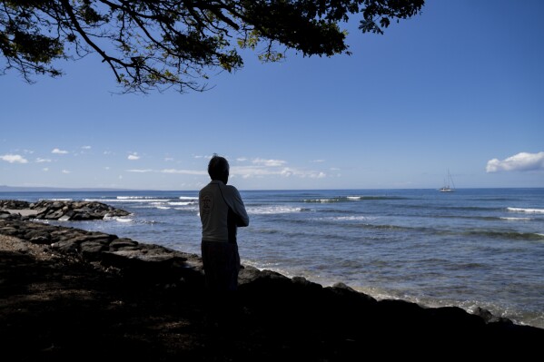 Abraham "Snake" Ah Hee, one of the first crew members of Hokulea - the Polynesian double-hulled voyaging canoe, looks at the ocean at Launipoko Beach Park on Friday, Feb. 23, 2024, in Lahaina, Hawaii. (AP Photo/Mengshin Lin)