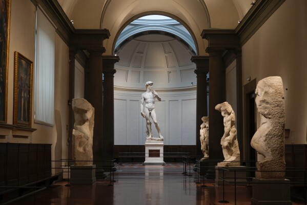 Michelangelo's 16th century statue of David is seen on display at the Accademia gallery, in Florence, central Italy, Monday, March 18, 2024. Michelangelo’s David has been a towering figure in Italian culture since its completion in 1504. But curators worry the marble statue’s religious and political significance is being diminished by the thousands of refrigerator magnets and other souvenirs focusing on David’s genitalia. The Galleria dell’Accademia’s director has positioned herself as David’s defender and takes swift aim at those profiteering from his image. (AP Photo/Andrew Medichini)