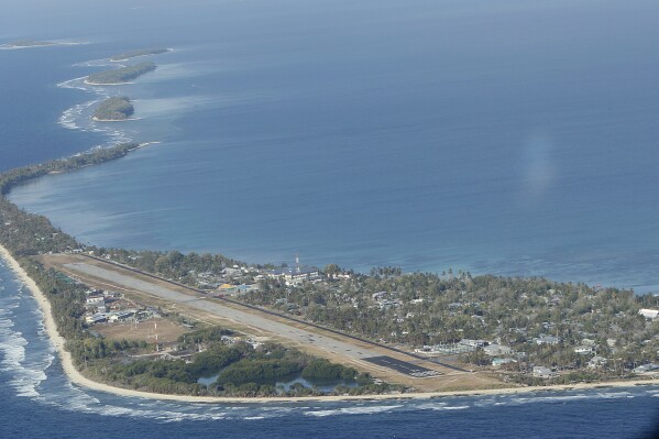 FILE - Funafuti, the main island of the nation state of Tuvalu, is photographed from a Royal New Zealand airforce C130 aircraft as it approaches the tiny South Pacific nation. On Friday, Jan 26, 2024, the small Pacific island of Tuvalu head to the polls to select representatives for its 16-seat parliament. (AP Photo/Alastair Grant, File)