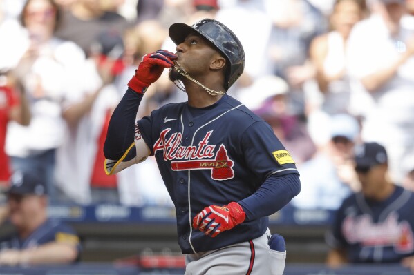 Atlanta Braves' Ozzie Albies reacts after his three-run home run against the Milwaukee Brewers during the eighth inning of a baseball game, Sunday, July 23, 2023, in Milwaukee. (AP Photo/Jeffrey Phelps)