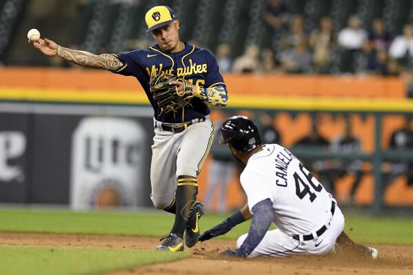 Milwaukee Brewers second baseman Kelton Wong throws to first after forcing out Detroit Tigers' Jeimer Candelario on a double play hit into by Eric Haase during the fifth inning of a baseball game in Detroit, Tuesday, Sept. 14, 2021. (AP Photo/Lon Horwedel)