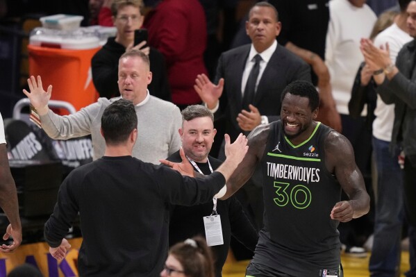 Minnesota Timberwolves forward Julius Randle, right, is congratulated by Los Angeles Lakers head coach JJ Redick after the Timberwolves defeated the Lakers in Game 5 of an NBA basketball first-round playoff series Wednesday, April 30, 2025, in Los Angeles. (AP Photo/Mark J. Terrill)