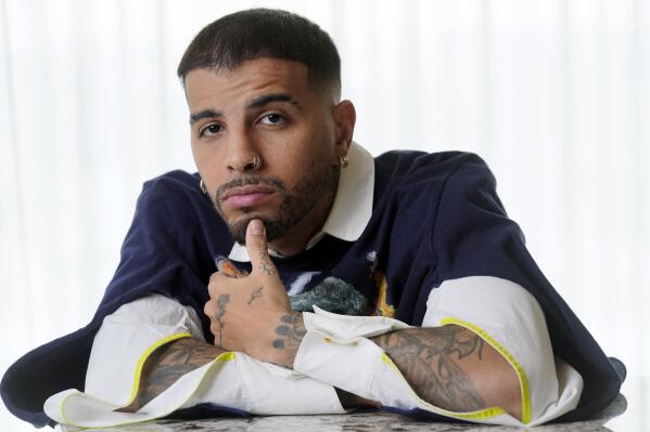 Singer/rapper Rauw Alejandro, named one of AP's breakthrough entertainers of the year, poses for a portrait at the Aria Hotel in Las Vegas on Nov. 18, 2021. (AP Photo/Chris Pizzello)